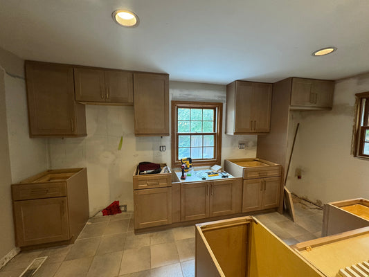 Stained Shaker wall and base cabinets installed, before countertops.