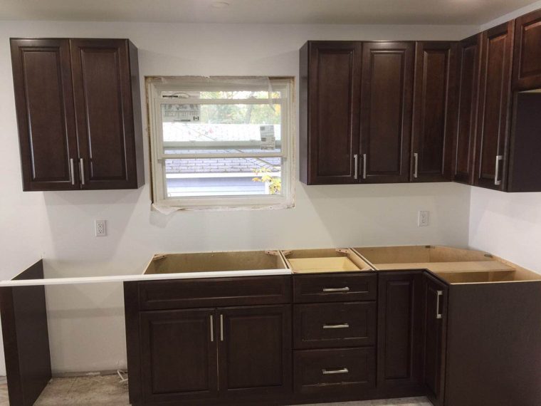 Dark cabinets around the sink window during installation