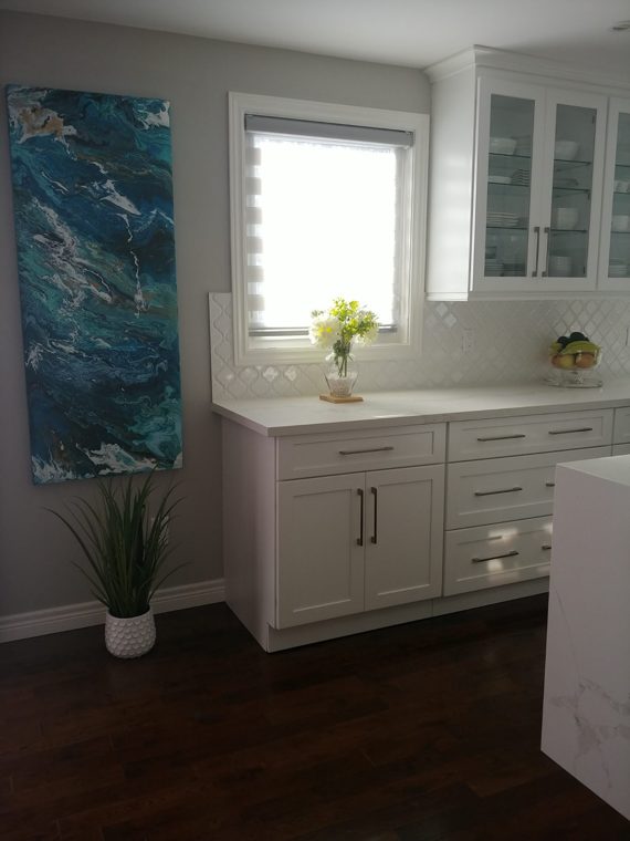 White glass-door cabinets beside the kitchen window