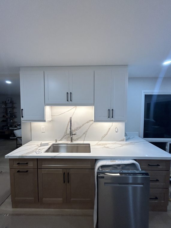 Wood-tone sink cabinets beneath white upper cabinets
