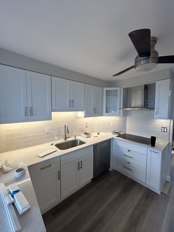 White kitchen with completed countertops and under-cabinet lighting