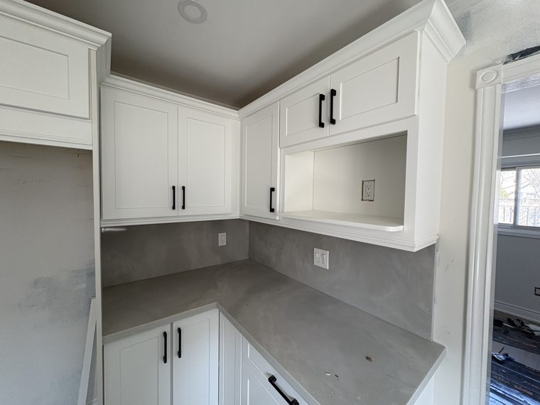 Corner of a white kitchen as installation continues