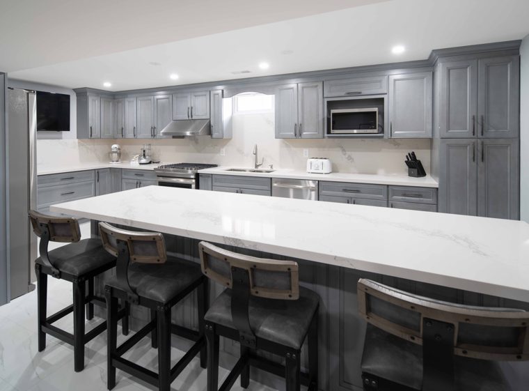 Grey kitchen with an island and white countertops