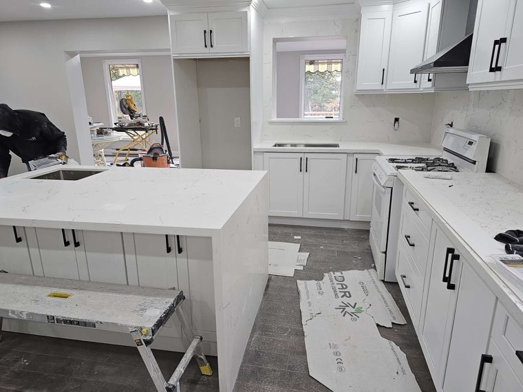White kitchen cabinets and a peninsula countertop