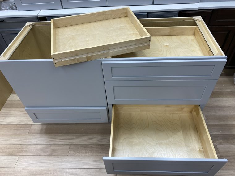 Grey drawer cabinet with wooden drawers extended