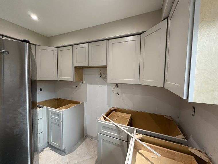 White corner cabinetry awaiting countertops