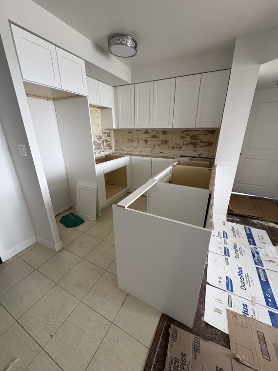 Cabinets positioned on site during a real kitchen project.