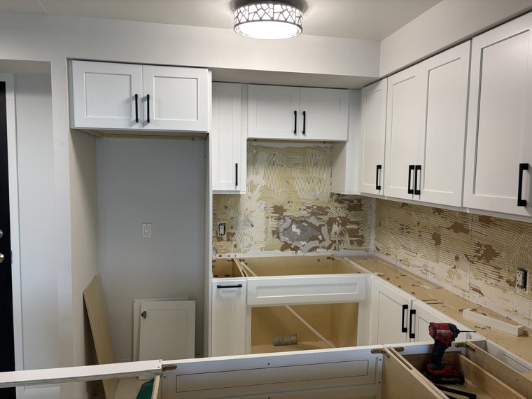 White kitchen cabinets during installation