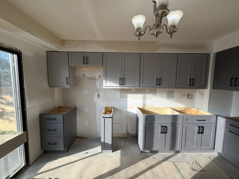 Grey wall and base cabinets being fitted