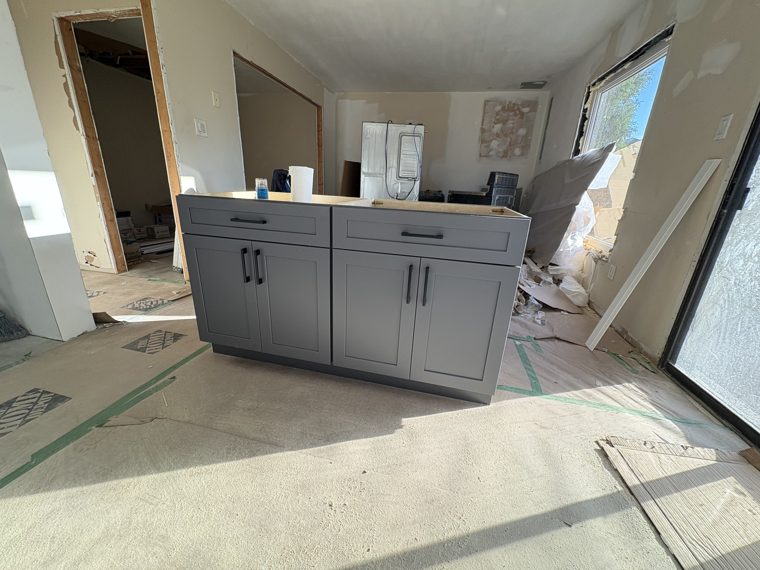 Grey peninsula cabinetry before countertop installation