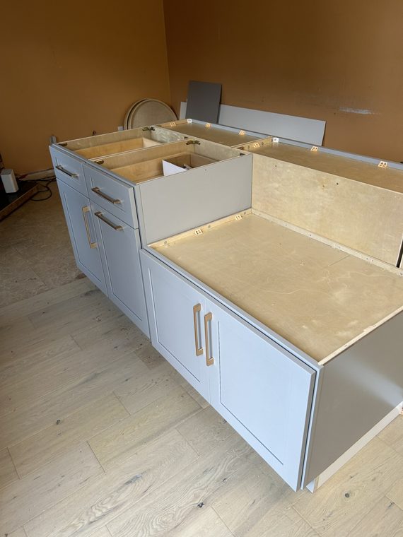 Installed cabinet bases ready for countertop measurement.